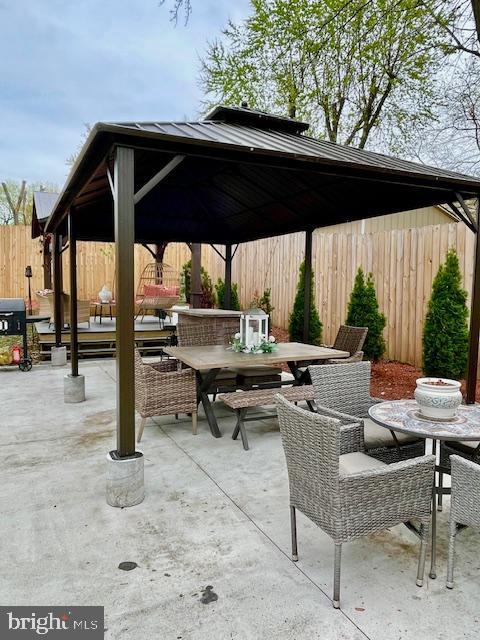 704 Pritchard Ln, Upper Marlboro, MD 20774 - view of patio featuring outdoor dining space, fence, and a gazebo