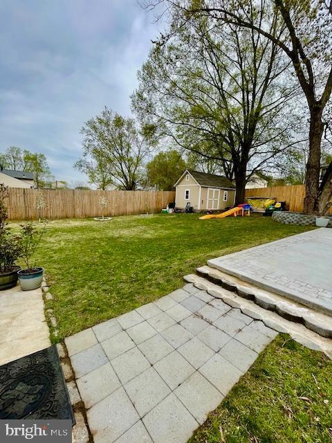 704 Pritchard Ln, Upper Marlboro, MD 20774 - view of yard with a fenced backyard, an outbuilding, and a patio area