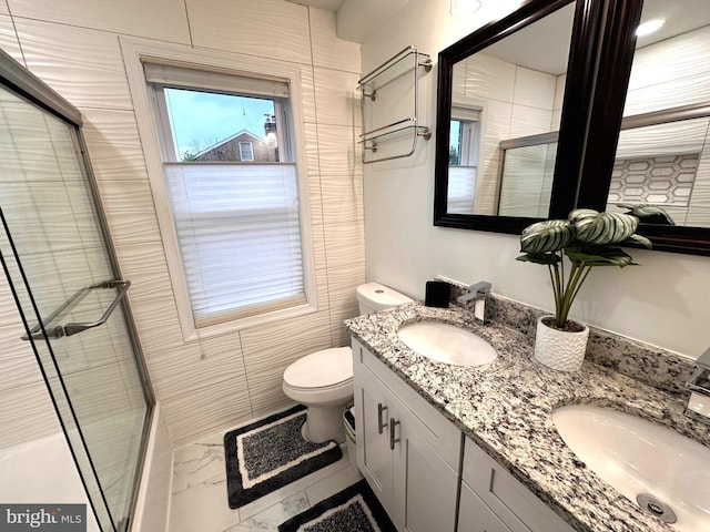 14427 Seneca Rd, Germantown, MD 20874 - bathroom featuring marble finish flooring, double vanity, a tile shower, toilet, and healthy amount of natural light