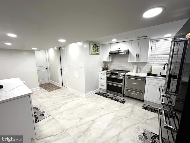 14427 Seneca Rd, Germantown, MD 20874 - kitchen with range with two ovens, dishwashing machine, under cabinet range hood, baseboards, and light marble finish floors