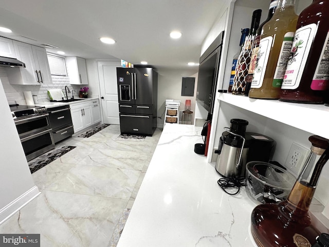 14427 Seneca Rd, Germantown, MD 20874 - kitchen with black fridge with ice dispenser, range hood, recessed lighting, electric panel, and white cabinets