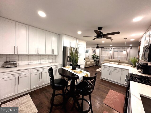 14427 Seneca Rd, Germantown, MD 20874 - kitchen featuring stainless steel fridge, a ceiling fan, gas range oven, white cabinetry, and recessed lighting