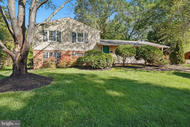 tri-level home with a front yard