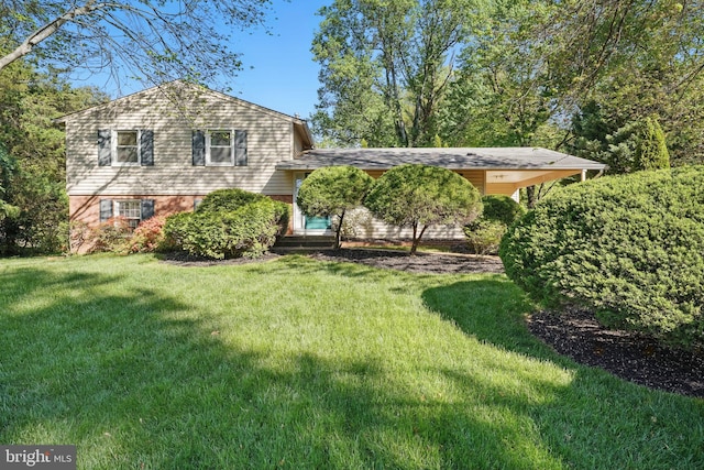 tri-level home with a front yard