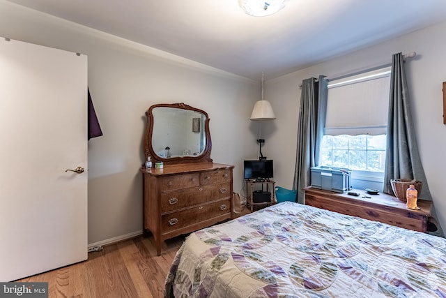 bedroom featuring light wood-type flooring and baseboards