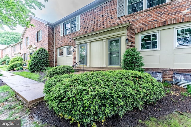 property entrance featuring brick siding