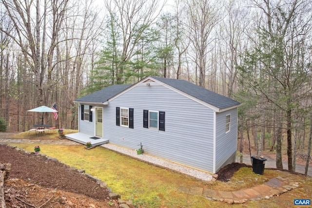 115 Circle Rd, Stanardsville, VA 22973 - view of front of house with a trampoline, a shingled roof, and a front lawn