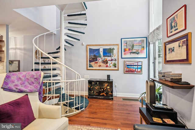 311 S American St, Philadelphia, PA 19106 - living room with stairs, wood finished floors, and baseboards