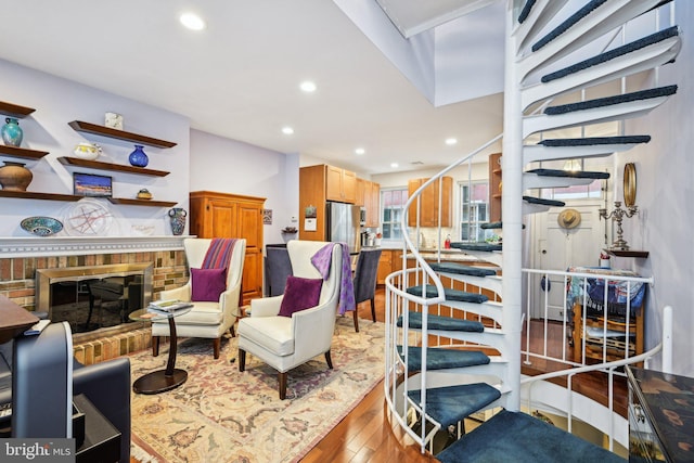 311 S American St, Philadelphia, PA 19106 - living room with a brick fireplace, wood finished floors, and recessed lighting