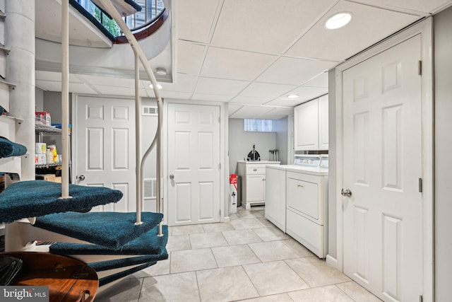 311 S American St, Philadelphia, PA 19106 - laundry area with cabinet space, separate washer and dryer, light tile patterned floors, recessed lighting, and plenty of natural light