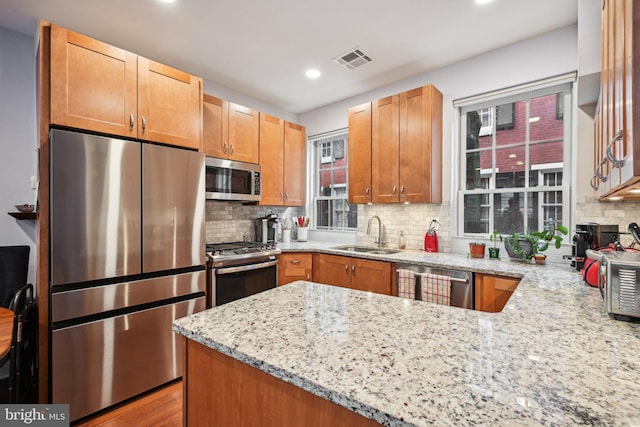 311 S American St, Philadelphia, PA 19106 - kitchen with stainless steel appliances, a sink, light stone counters, tasteful backsplash, and recessed lighting