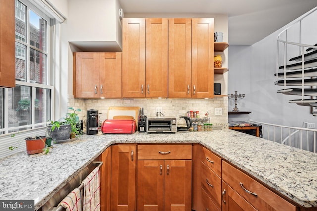 311 S American St, Philadelphia, PA 19106 - kitchen with open shelves, tasteful backsplash, and light stone counters
