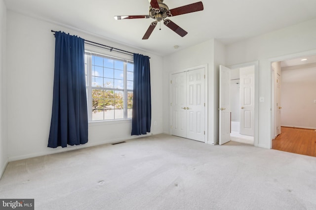unfurnished bedroom featuring a closet, visible vents, carpet flooring, and baseboards