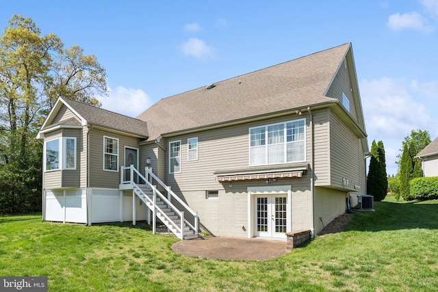 rear view of house featuring stairs, central AC, a patio area, french doors, and a lawn