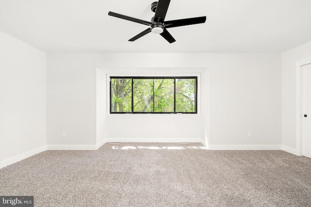 empty room with carpet floors, ceiling fan, and baseboards
