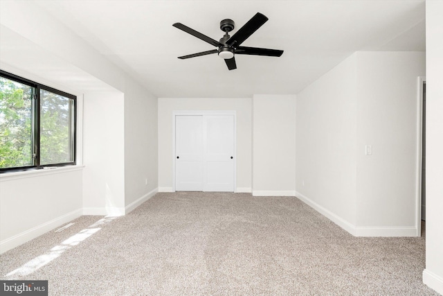 interior space with baseboards and ceiling fan