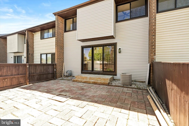 back of house with fence, a patio, and entry steps