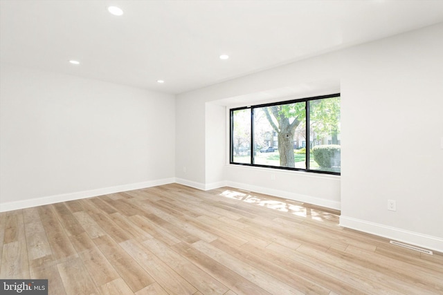 empty room featuring recessed lighting, baseboards, visible vents, and light wood-style flooring