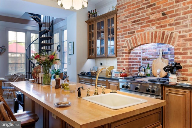 interior space featuring stairway, stove, and a sink