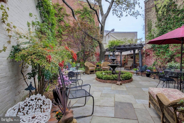 view of patio featuring a pergola, outdoor dining space, and fence