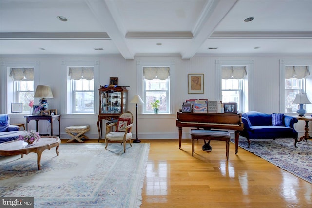 sitting room featuring beamed ceiling, light wood-style floors, crown molding, and coffered ceiling