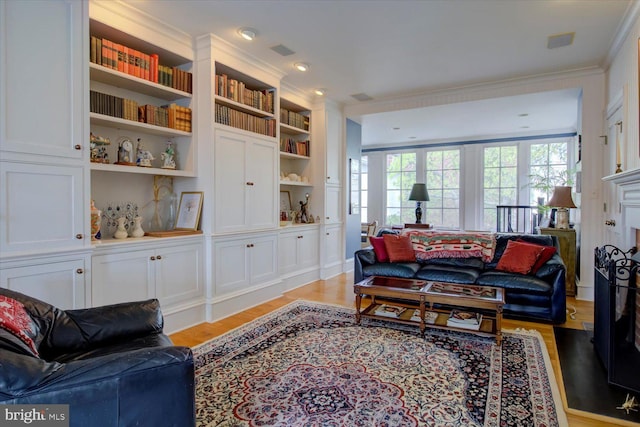 living room featuring light wood-style floors and ornamental molding