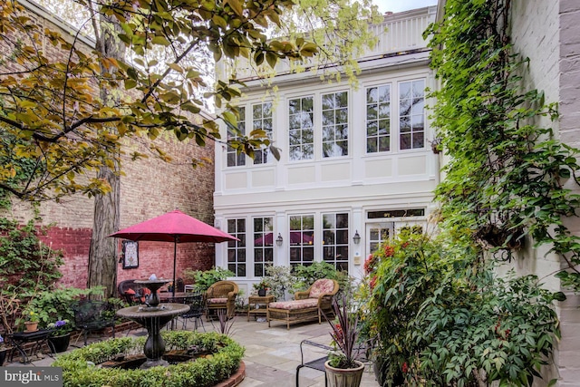 rear view of property featuring a patio area