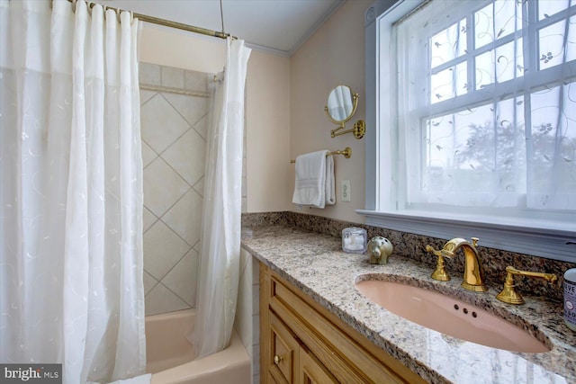bathroom featuring shower / bathtub combination with curtain, ornamental molding, and vanity