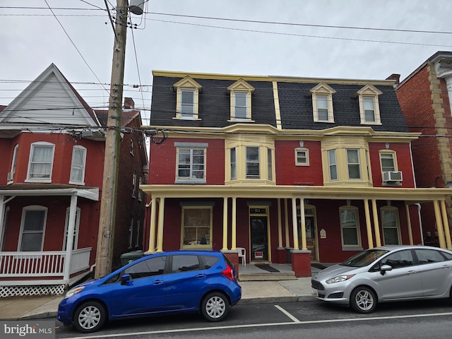 view of property with mansard roof
