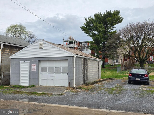 detached garage featuring fence