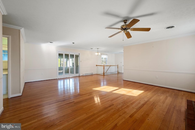 unfurnished living room featuring a baseboard heating unit, a ceiling fan, wood finished floors, and crown molding