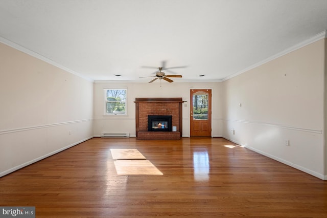 unfurnished living room featuring a baseboard heating unit, baseboards, a ceiling fan, wood finished floors, and a fireplace