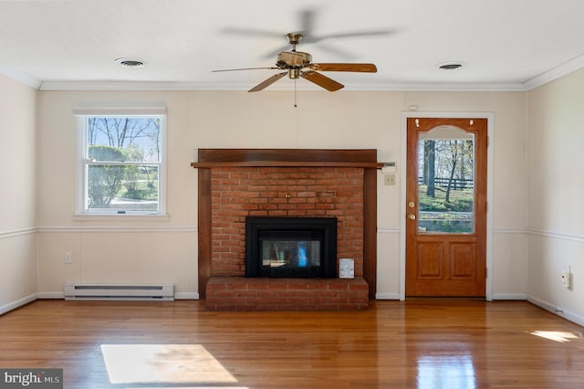 unfurnished living room with a baseboard radiator, a ceiling fan, wood finished floors, ornamental molding, and visible vents