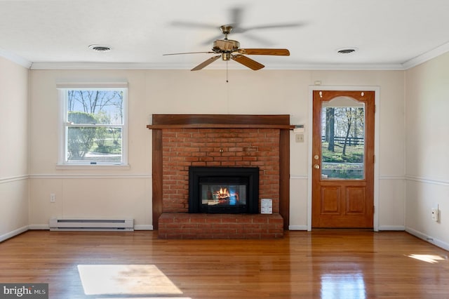 unfurnished living room with baseboard heating, crown molding, a ceiling fan, wood finished floors, and visible vents