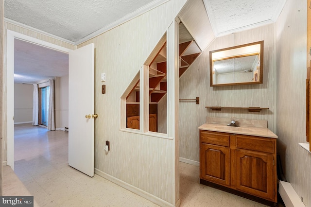 bathroom with crown molding, vanity, tile patterned floors, and a textured ceiling