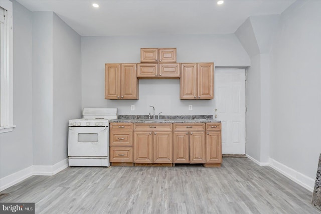 kitchen featuring white range with gas stovetop, baseboards, recessed lighting, light wood-style floors, and a sink