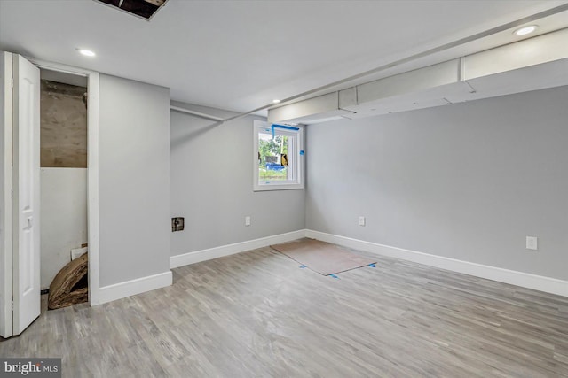 below grade area featuring wood finished floors, baseboards, and recessed lighting