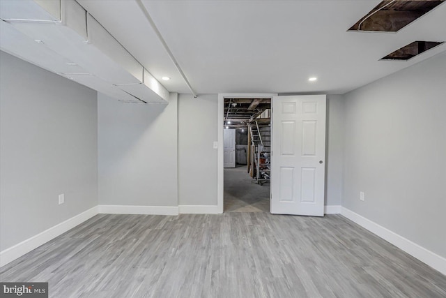 finished below grade area with wood finished floors, baseboards, and recessed lighting