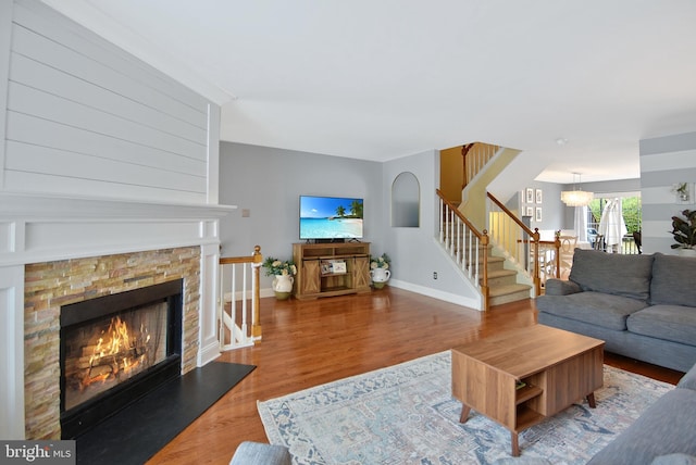 703 Harbour Ridge Ln, Downingtown, PA 19335 - living room with a fireplace, stairway, baseboards, and wood finished floors