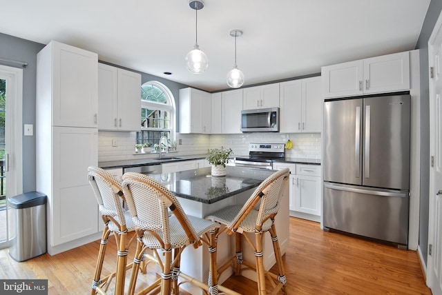 703 Harbour Ridge Ln, Downingtown, PA 19335 - kitchen with stainless steel appliances, light wood-style floors, white cabinets, and a sink