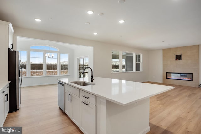 10030 Wilkes, Williamsport, MD 21795 - kitchen featuring a sink, appliances with stainless steel finishes, a notable chandelier, and light wood finished floors