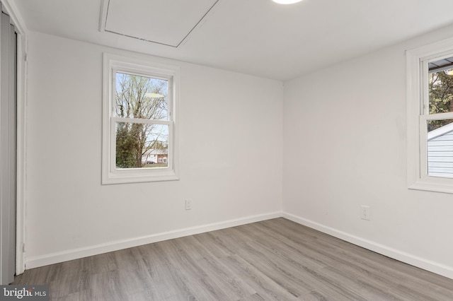 unfurnished room with light wood-style floors and baseboards