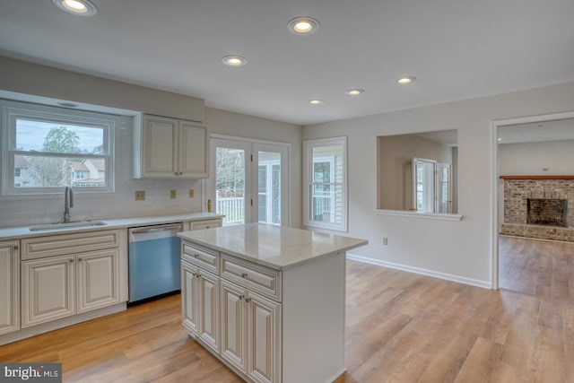 kitchen with a sink, recessed lighting, light wood-style flooring, and dishwasher
