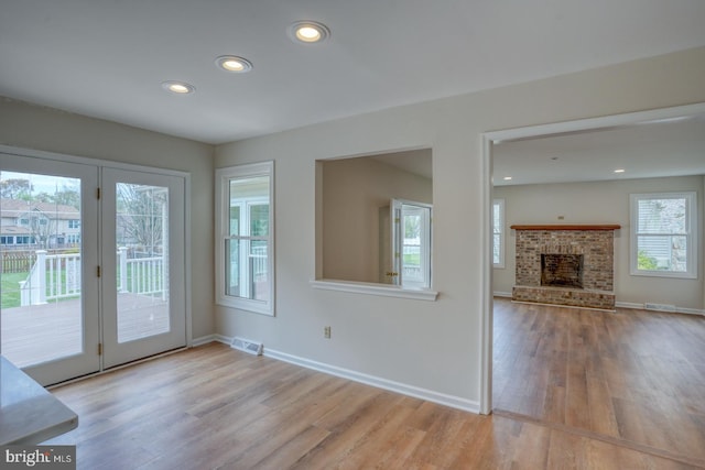interior space featuring recessed lighting, baseboards, visible vents, and wood finished floors