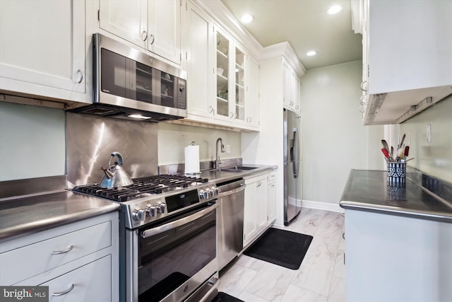 kitchen featuring recessed lighting, white cabinets, appliances with stainless steel finishes, marble finish floor, and a sink