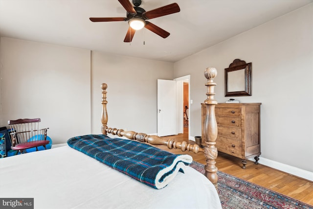 bedroom featuring baseboards, a ceiling fan, and wood finished floors