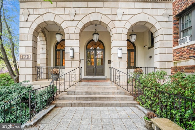 entrance to property with brick siding, french doors, and stone siding