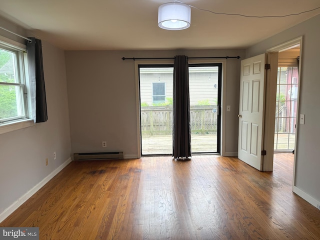 619 Cannon St, Chestertown, MD 21620 - unfurnished room with wood finished floors, baseboards, and a baseboard heating unit