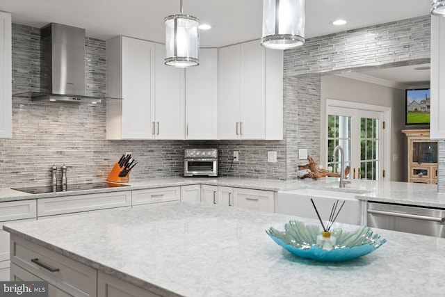 kitchen with ornamental molding, white cabinetry, backsplash, wall chimney exhaust hood, and stainless steel dishwasher