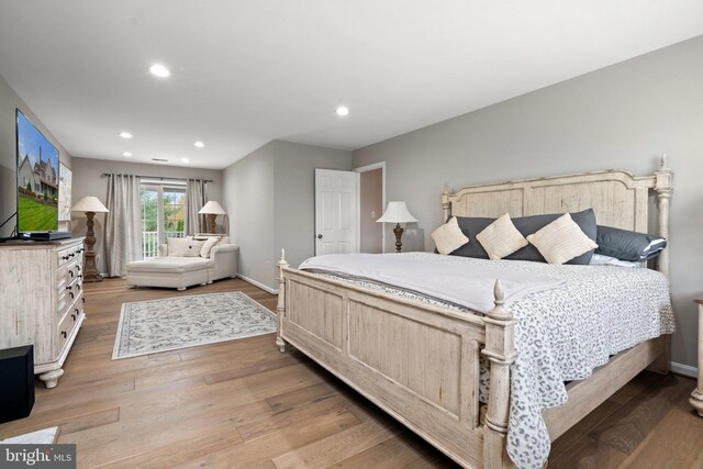 bedroom with baseboards, recessed lighting, and light wood-style floors